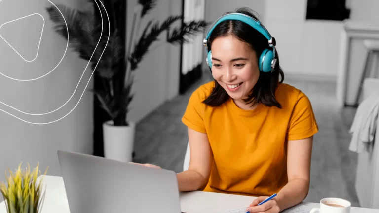 Happy girl at the notebook in headphones